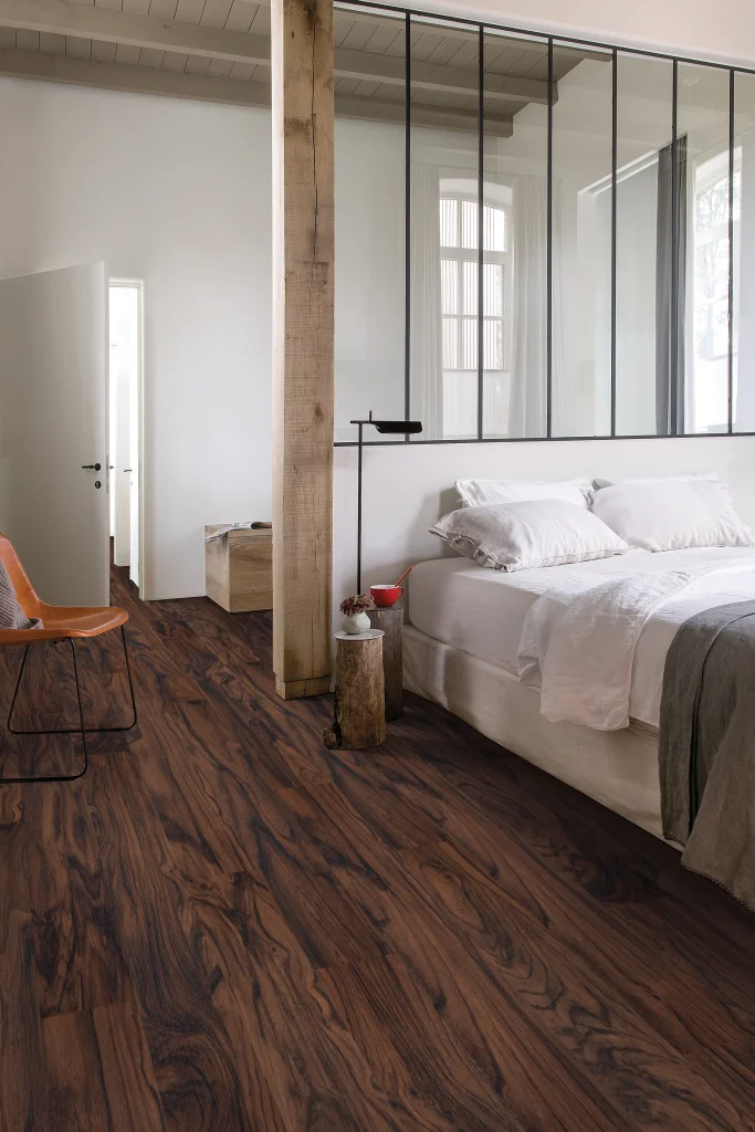 Modern bedroom with warm wood flooring in Horry County, SC, featuring natural grain, clean lines, and a bright, inviting interior